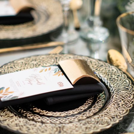Black glass embroidered with gold charger plates